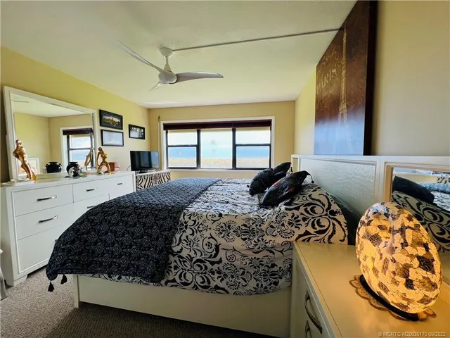 a bed room with a bed and a large window