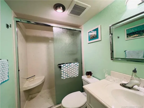 a living room with furniture a piano and a fireplace