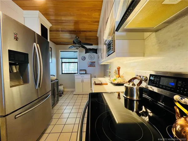 a dining room with furniture and a floor to ceiling window