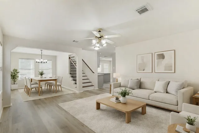 a living room with furniture and wooden floor