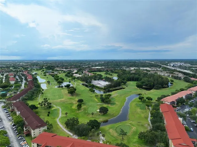 an aerial view of residential houses with outdoor space and trees