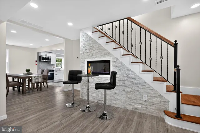 a living room with furniture or wooden floor and a fireplace