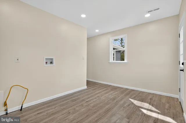 a view of room with window and wooden floor