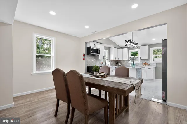 a view of a dining room with furniture and a fireplace