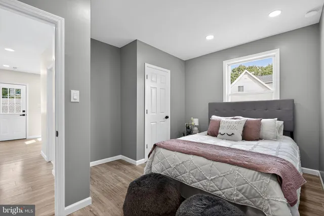 a bedroom with a bed and painting on the wall