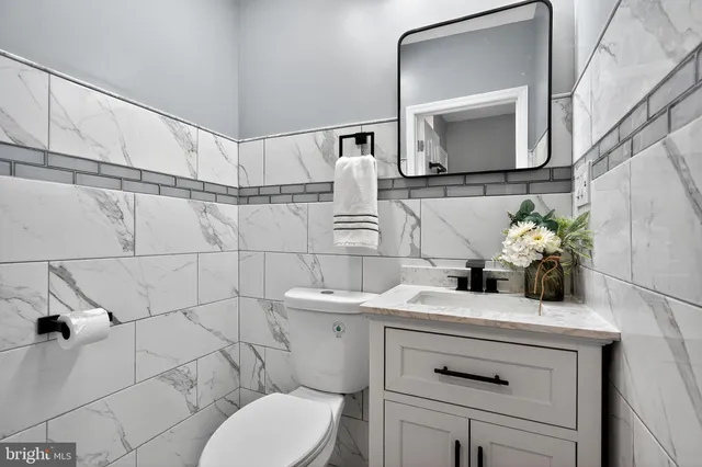a bathroom with a sink toilet and mirror
