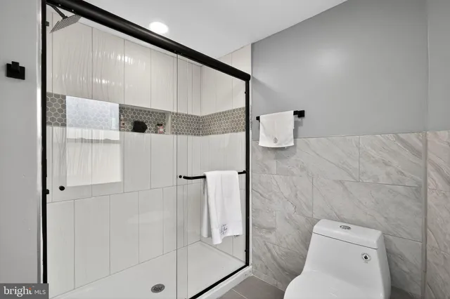 a bathroom with a shower and toilet