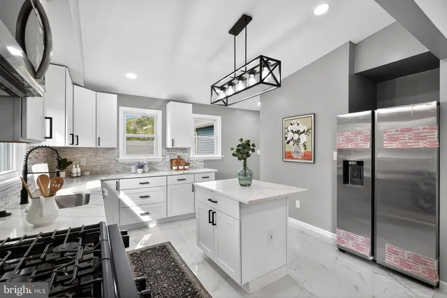 a kitchen with a sink appliances and cabinets