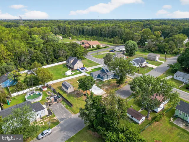 an aerial view of residential houses with outdoor space and street view