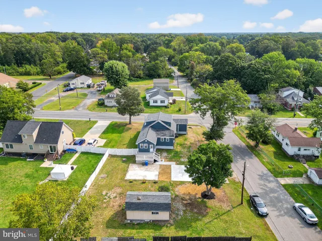 an aerial view of residential houses with outdoor space and street view