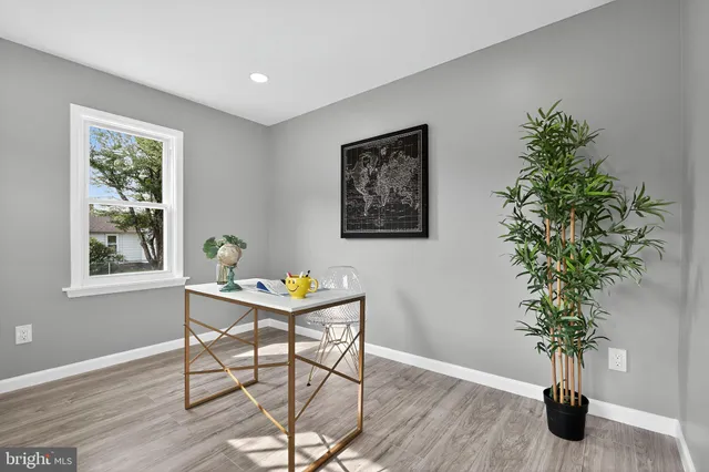 a view of a workspace with furniture window and wooden floor