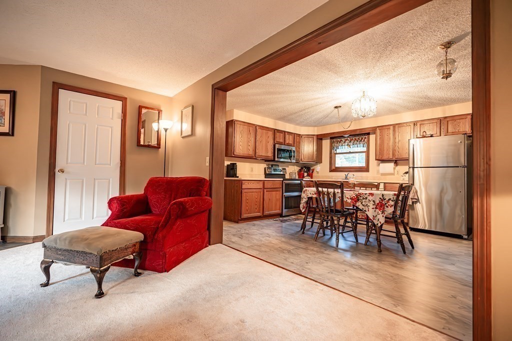 250 Rice Street Athol, MA 01331 - Photo 4 of 24 a living room with furniture and a dining table with kitchen view