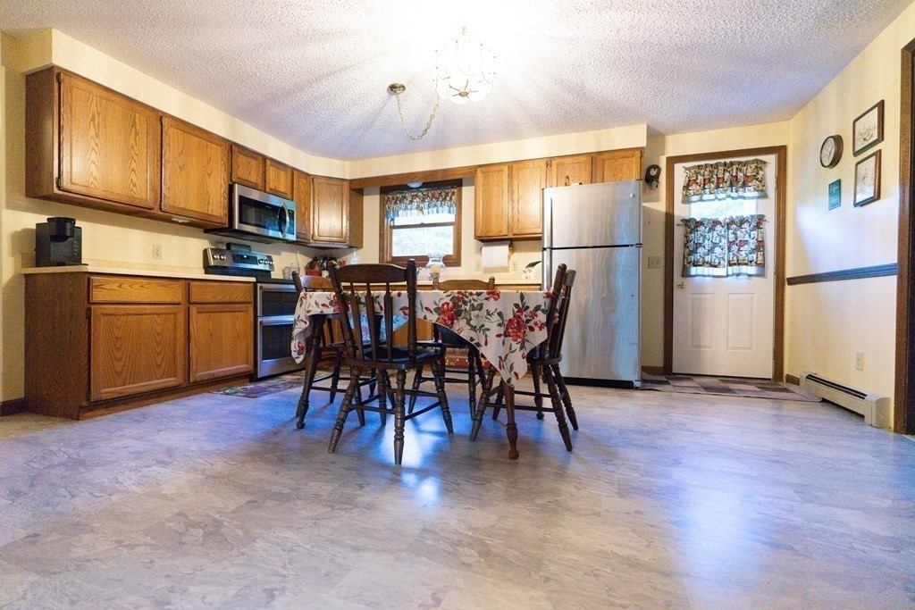 250 Rice Street Athol, MA 01331 - Photo 5 of 24 a view of dining room kitchen with furniture and stainless steel appliances