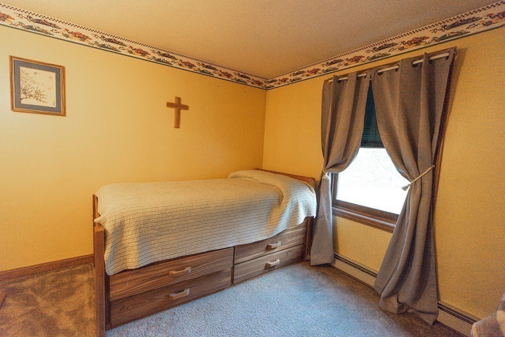 250 Rice Street Athol, MA 01331 - Photo 9 of 24 a bed sitting in a room next to a window