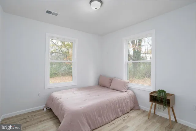 a bathroom with a granite countertop sink toilet and a mirror