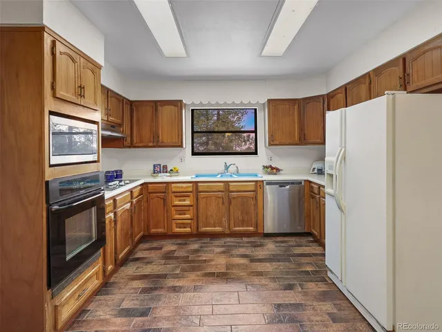 a kitchen with stainless steel appliances granite countertop a stove and a refrigerator