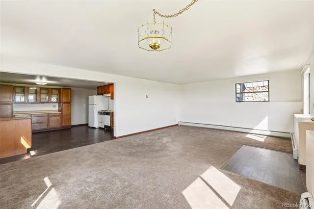 a green field with some trees in the background