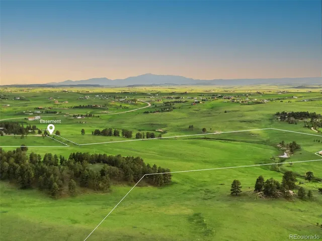 a view of a field with an ocean