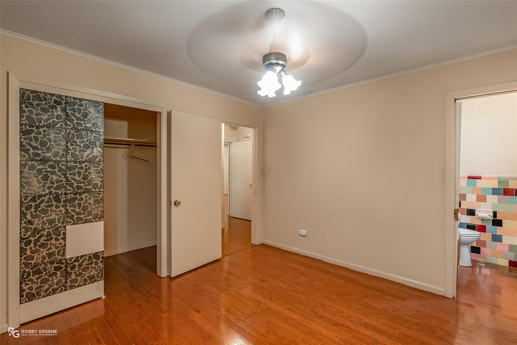 407 Fincher Road Minden, LA 71055 - Photo 23 of 28 an empty room with wooden floor cabinet and windows