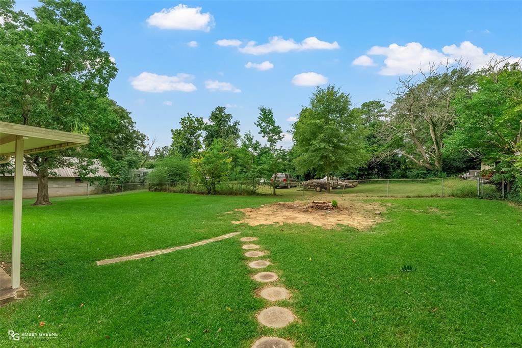 407 Fincher Road Minden, LA 71055 - Photo 24 of 28 a backyard of a house with lots of green space