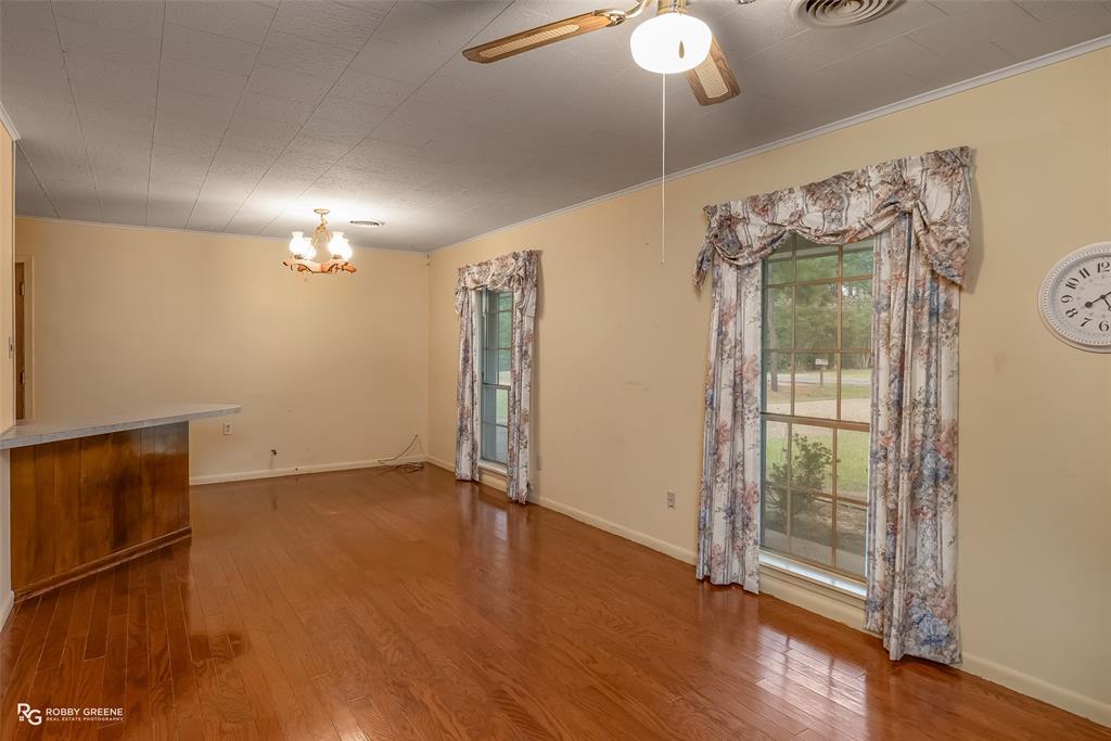 407 Fincher Road Minden, LA 71055 - Photo 9 of 28 a view of an empty room with wooden floor and a window