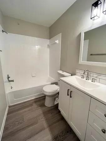 a bathroom with a sink toilet and shower