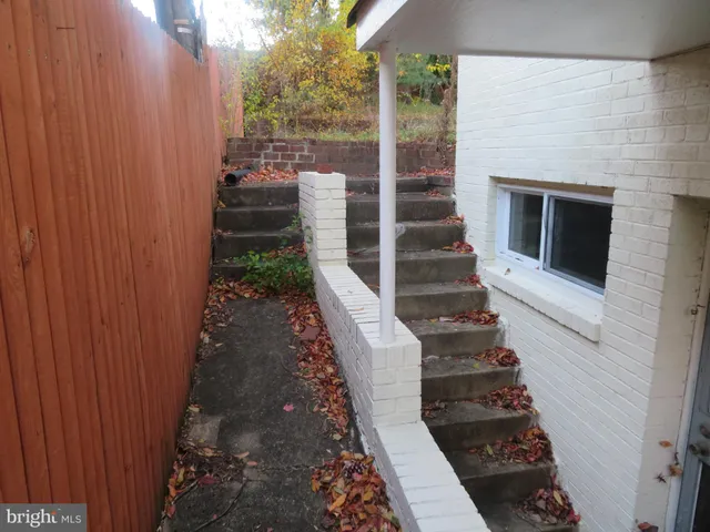 a view of a porch with wooden floor and fence