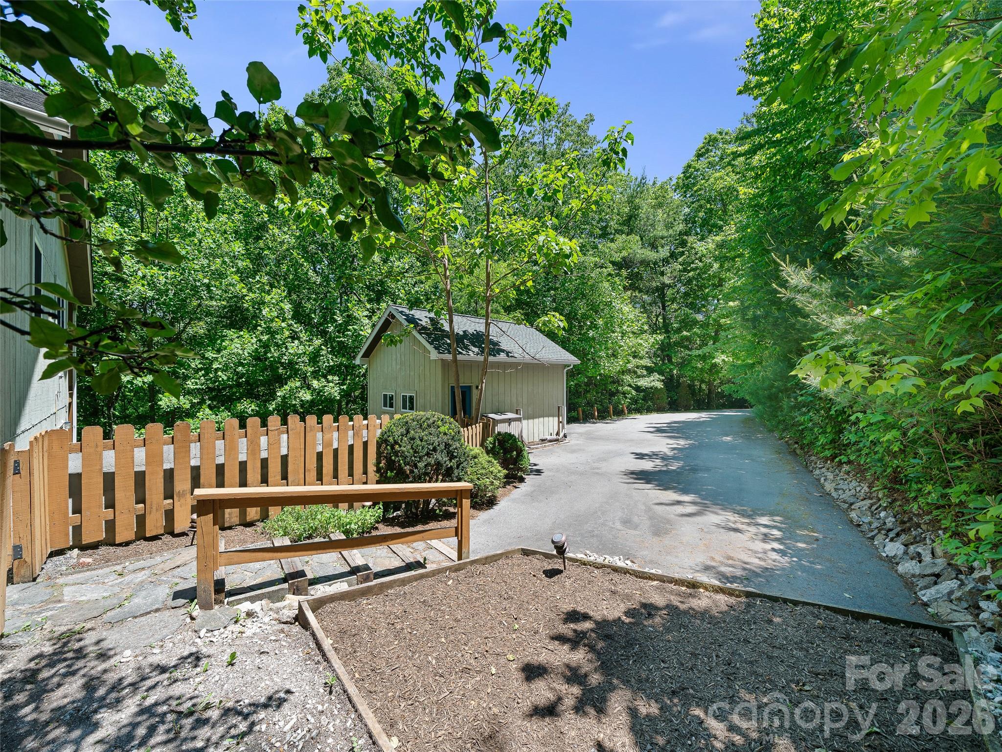 142 Wildflower Road Spruce Pine, NC 28777 - Photo 34 of 46 a wooden bench sitting in front of a house