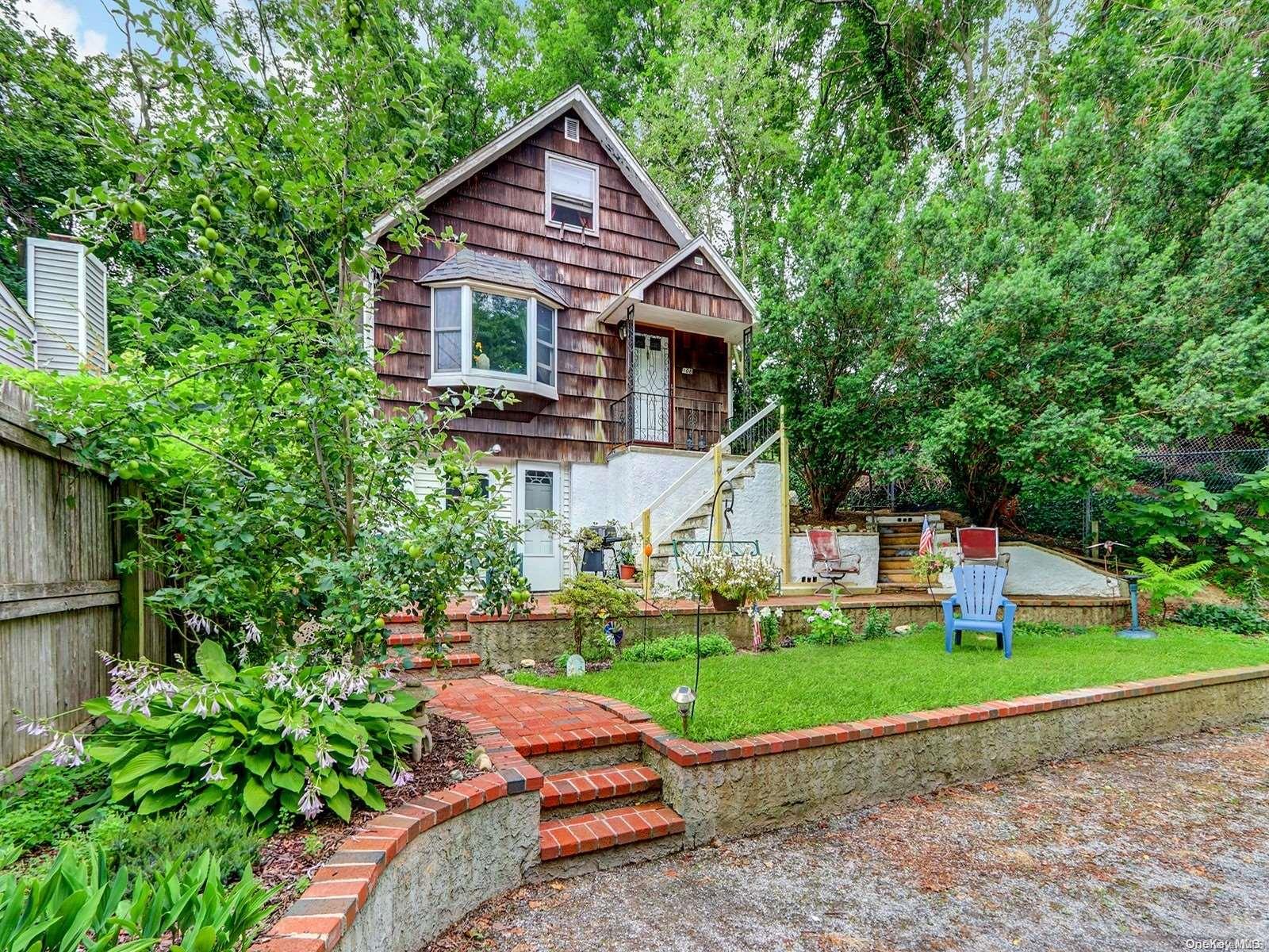 108 Lower Rocky Point Road Sound Beach, NY 11789 - Photo 1 of 1 a front view of a house with a yard and garage
