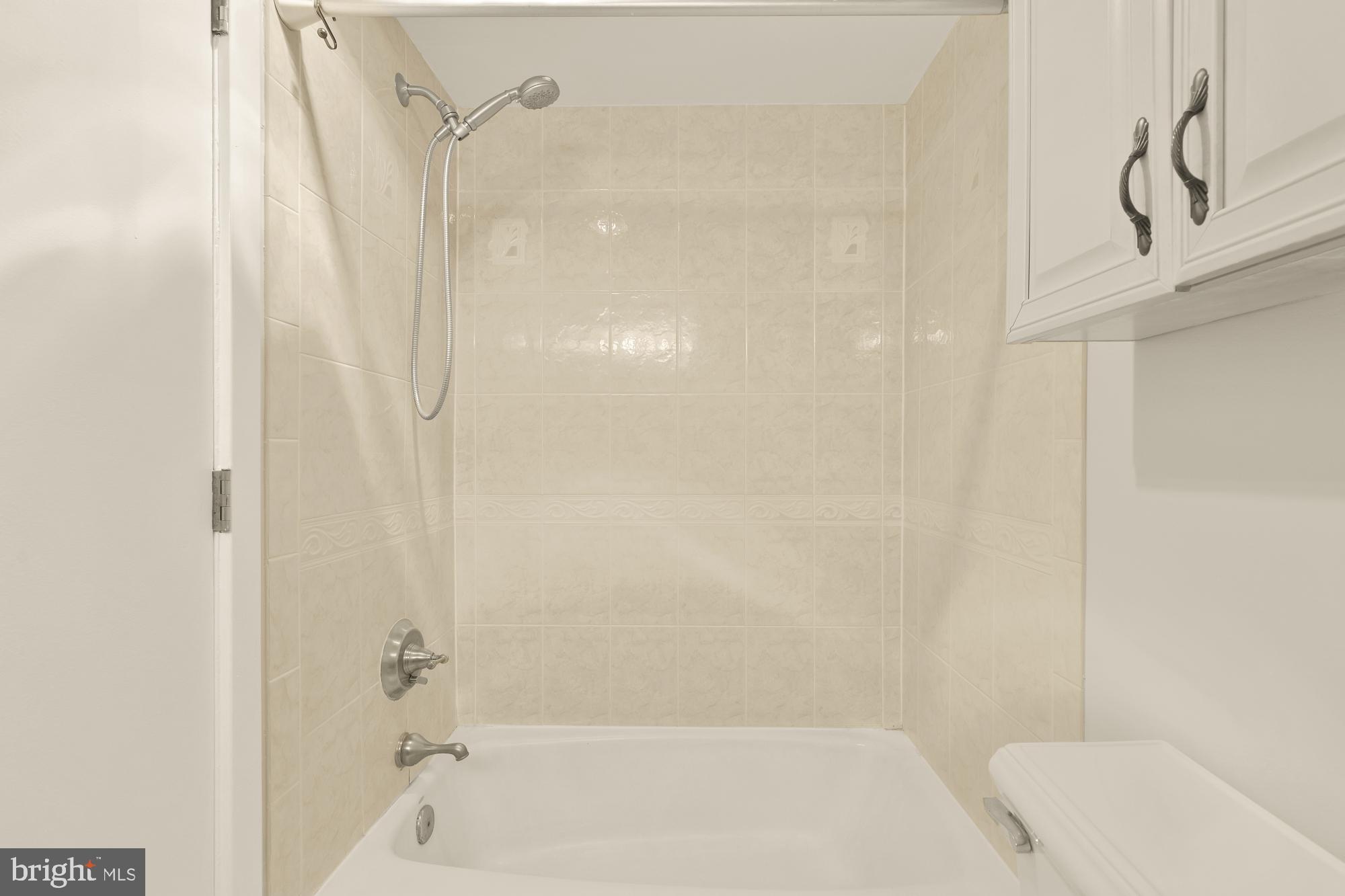 2114 N Street Northwest, Unit 11 Washington, DC 20037 - Photo 18 of 20 a bathroom with a bathtub and a shower