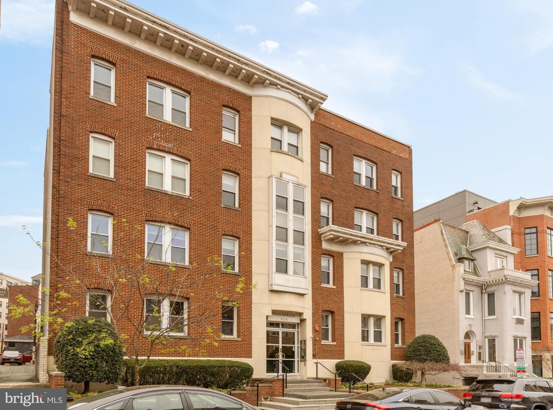 2114 N Street Northwest, Unit 11 Washington, DC 20037 - Photo 2 of 20 a front view of a building with lot of cars and trees