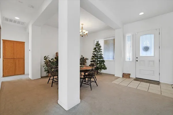 a view of a a dining room with furniture and window