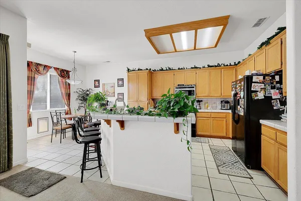 a view of a dining room with furniture and a chandelier