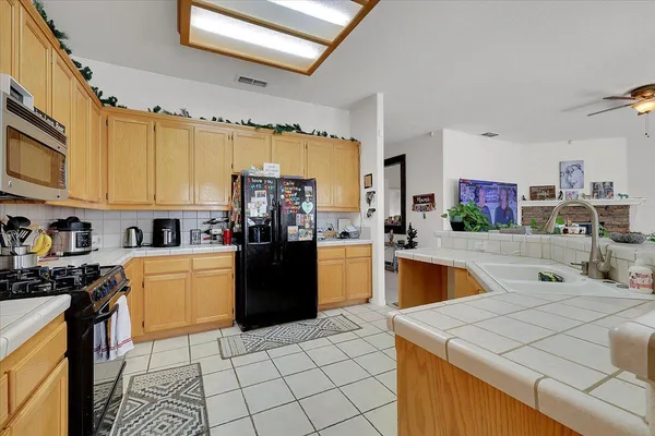 a kitchen with stainless steel appliances a stove sink and microwave
