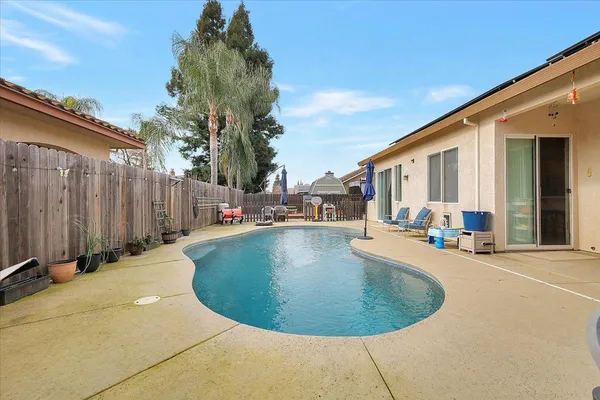 a view of a house with swimming pool and sitting area