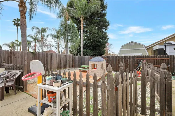 an outdoor living room with furniture and a fireplace