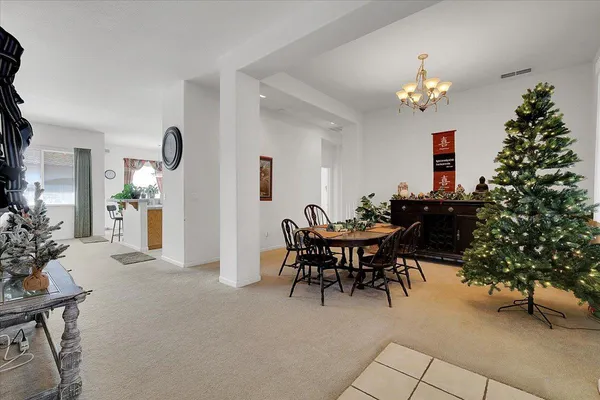 a view of a dining room with furniture and chandelier