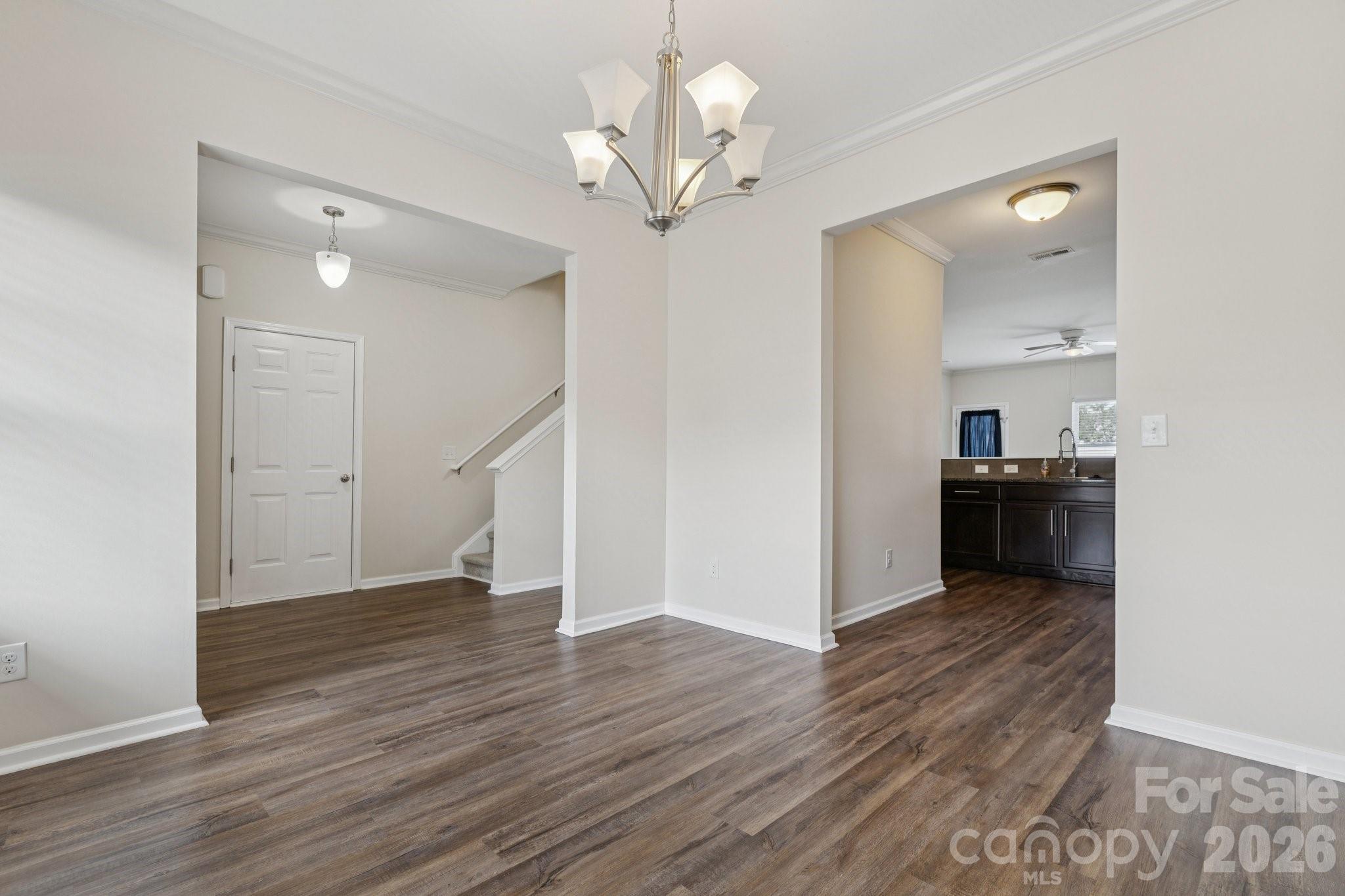 2822 Hopeton Court Monroe, NC 28110 - Photo 14 of 32 a view of a hallway with wooden floor and a kitchen