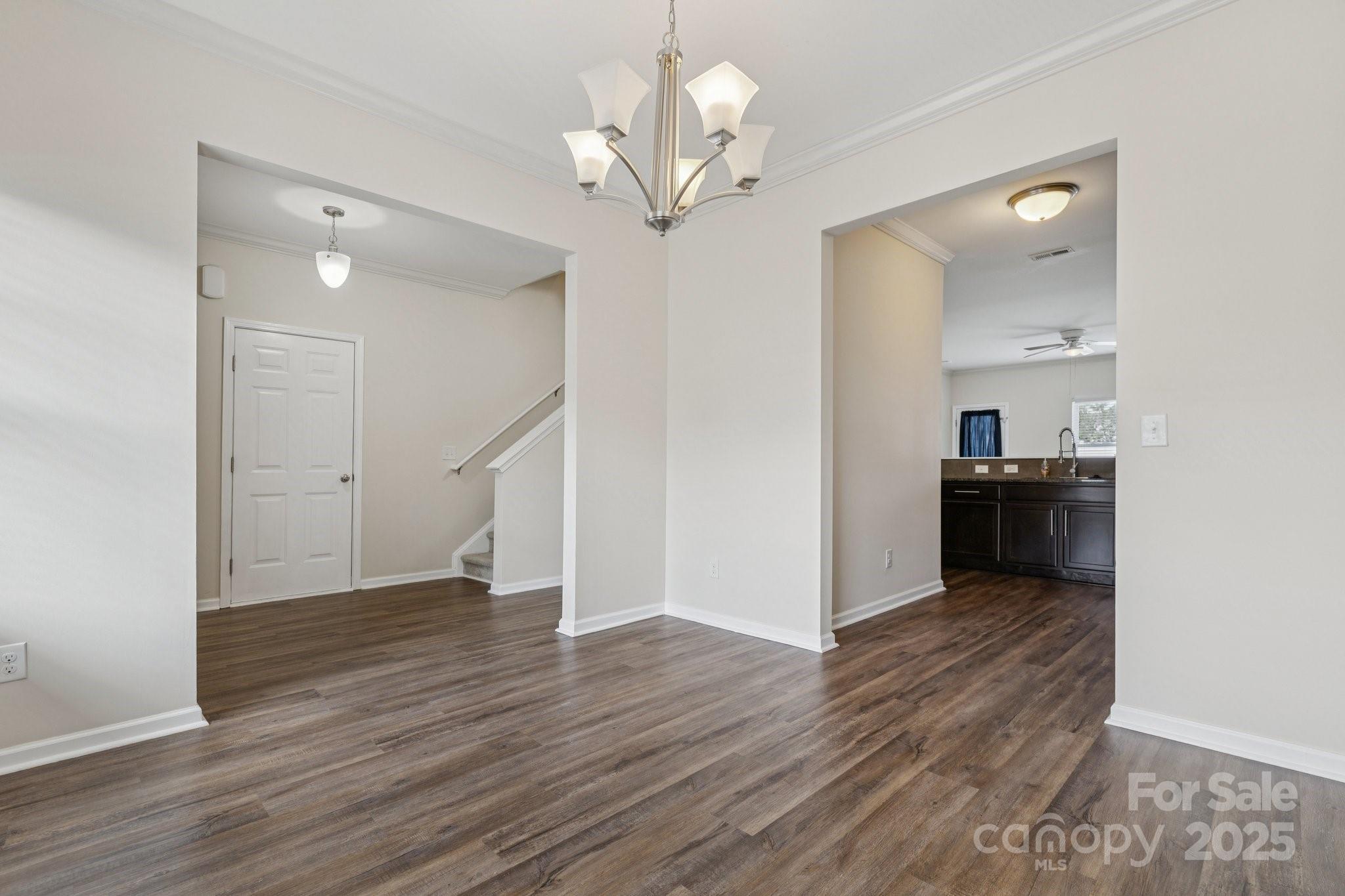 2822 Hopeton Court Monroe, NC 28110 - Photo 5 of 28 a view of a hallway with wooden floor and a kitchen