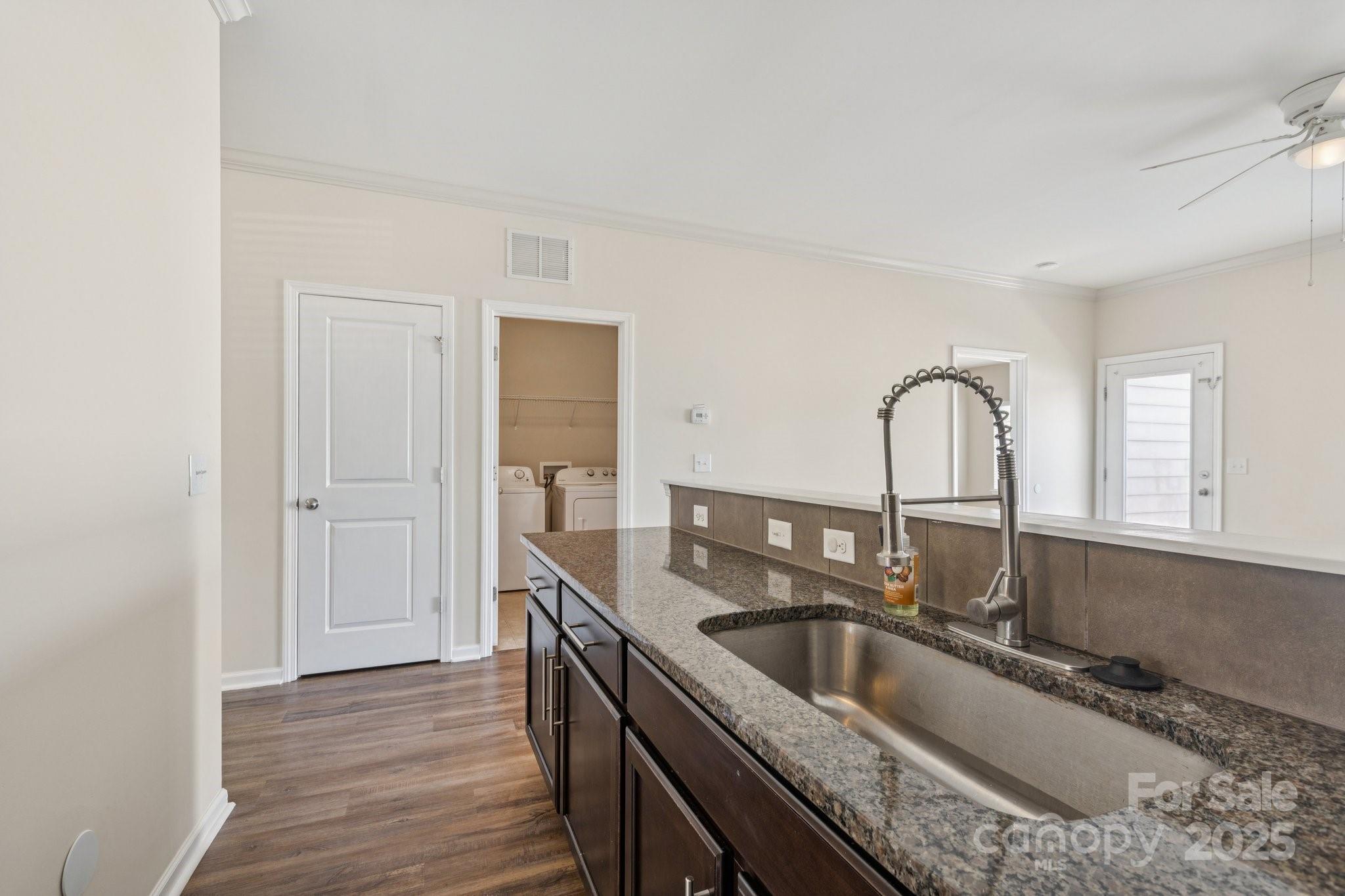 2822 Hopeton Court Monroe, NC 28110 - Photo 8 of 28 a kitchen with granite countertop a sink and a wooden floor