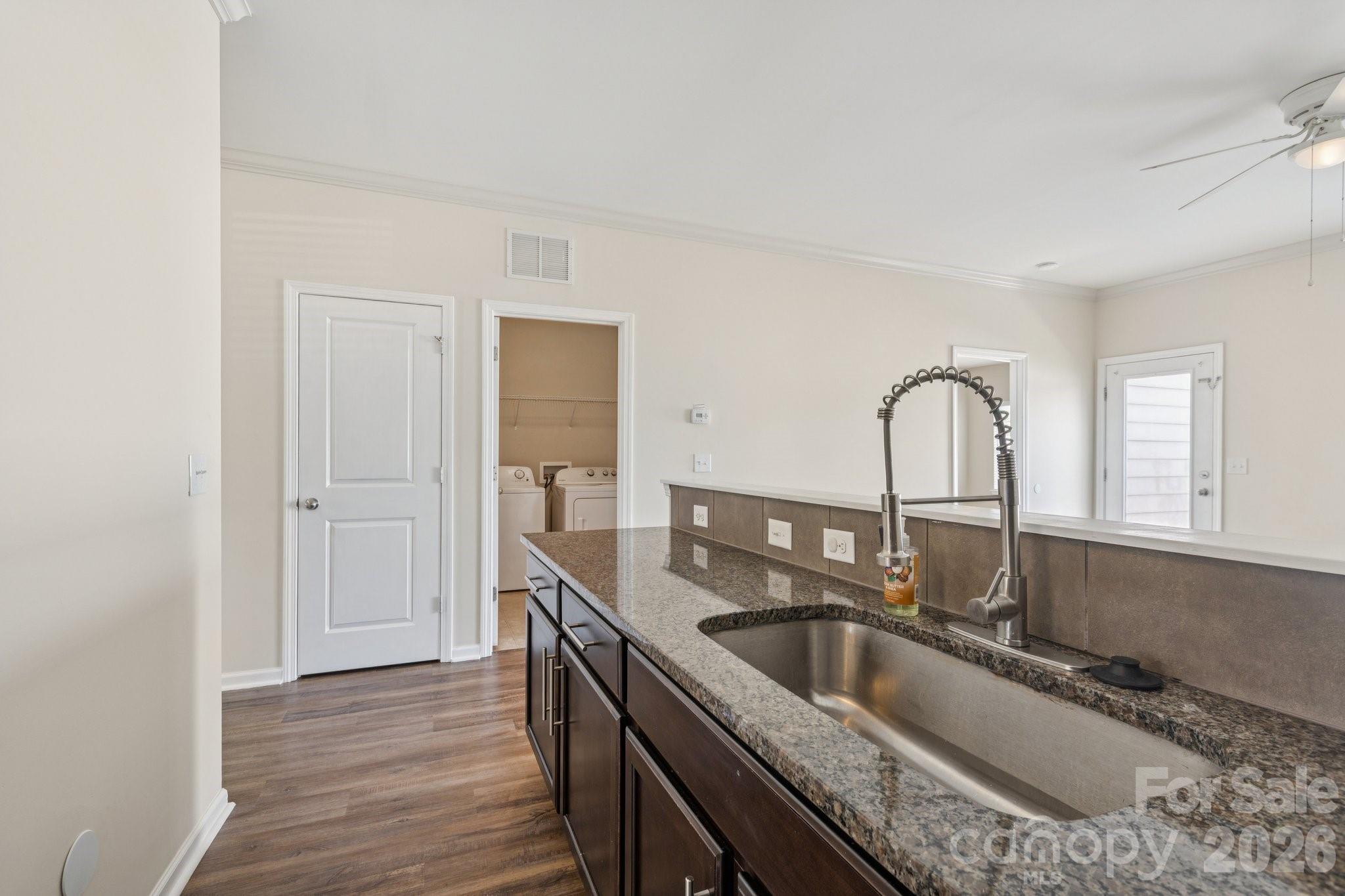 2822 Hopeton Court Monroe, NC 28110 - Photo 10 of 32 a kitchen with granite countertop a sink and a wooden floor