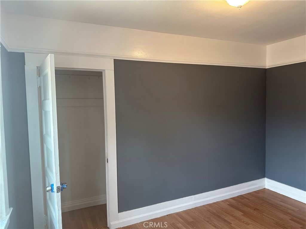 4 West 13th Street Merced, CA 95341 - Photo 12 of 23 a view of an empty room with wooden floor