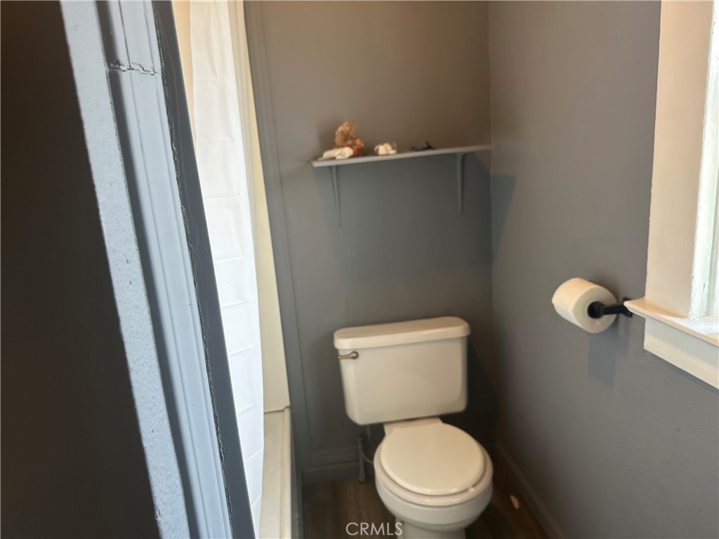 4 West 13th Street Merced, CA 95341 - Photo 16 of 23 a white toilet sitting in a bathroom next to a sink