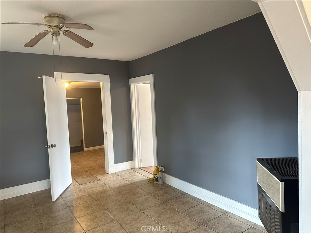 4 West 13th Street Merced, CA 95341 - Photo 8 of 23 an empty room with closet and a chandelier fan