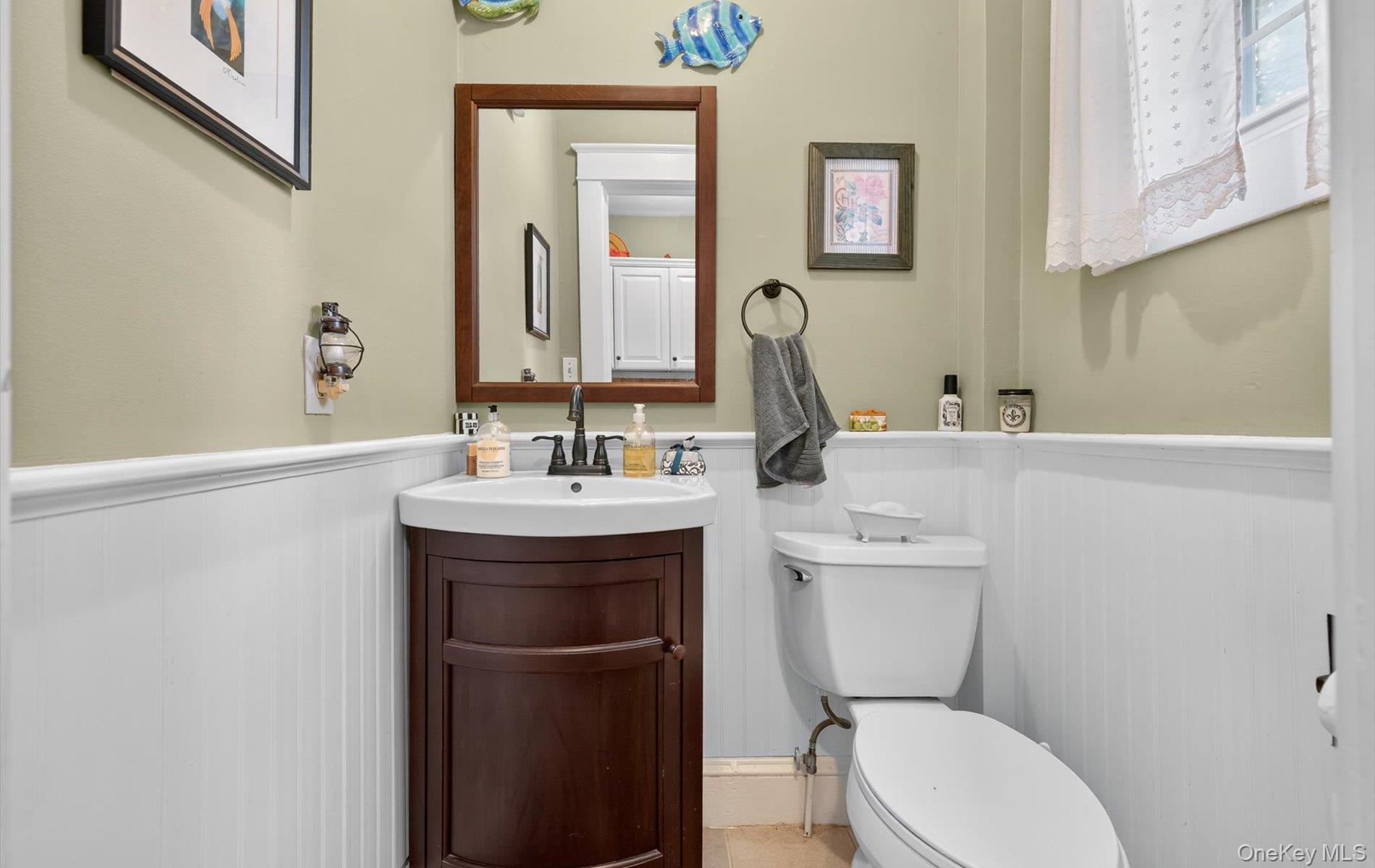 7 Ransom Avenue Sea Cliff, NY 11579 - Photo 21 of 42 a bathroom with a sink a toilet and mirror