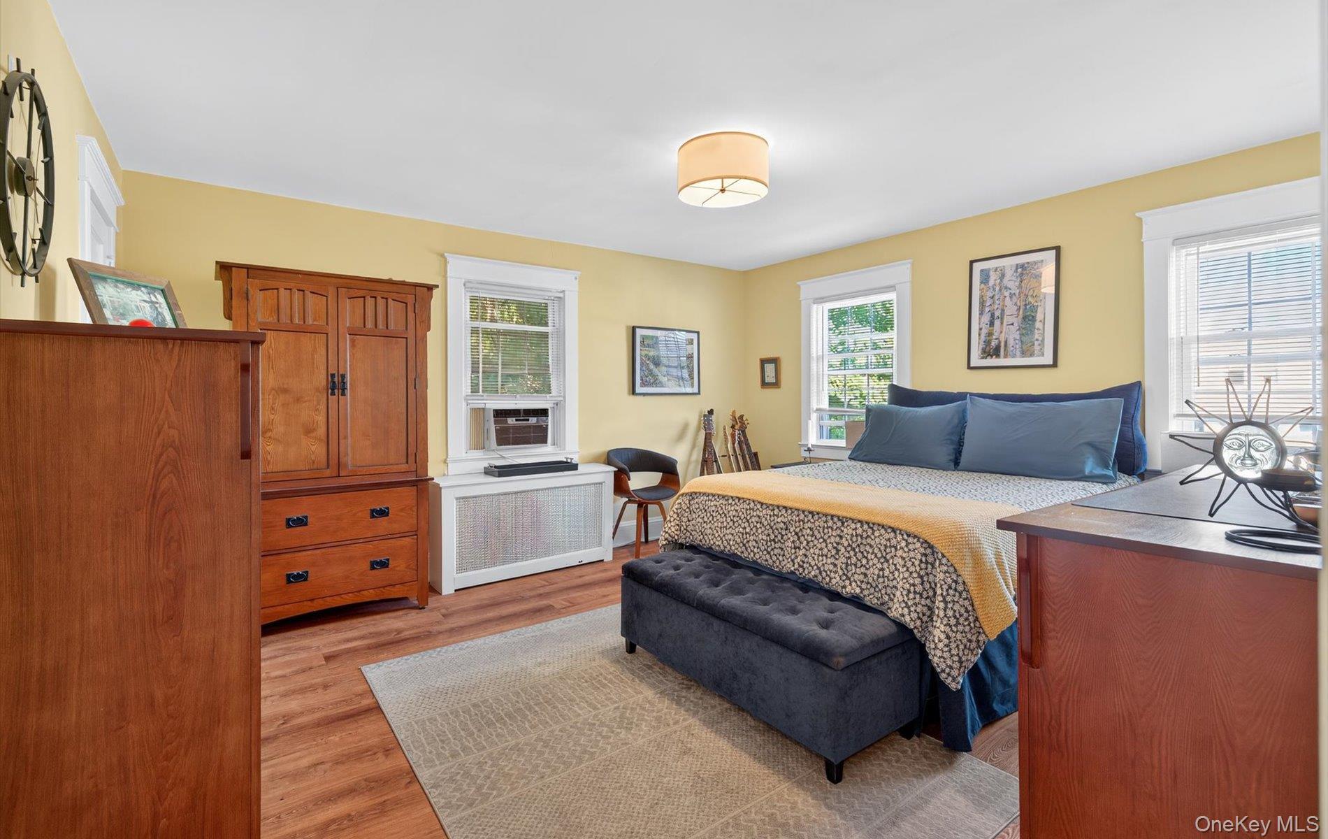 7 Ransom Avenue Sea Cliff, NY 11579 - Photo 24 of 42 a bedroom with a bed and wooden floor
