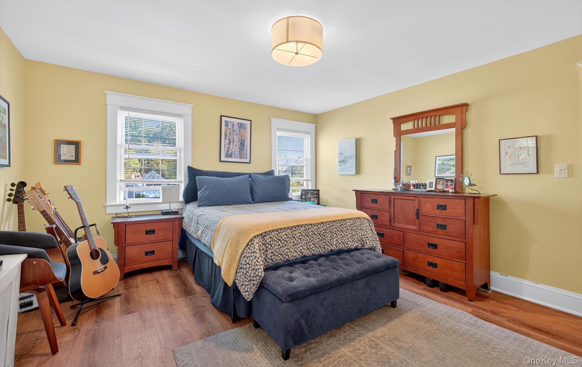 7 Ransom Avenue Sea Cliff, NY 11579 - Photo 25 of 42 a bedroom with a bed and a chandelier