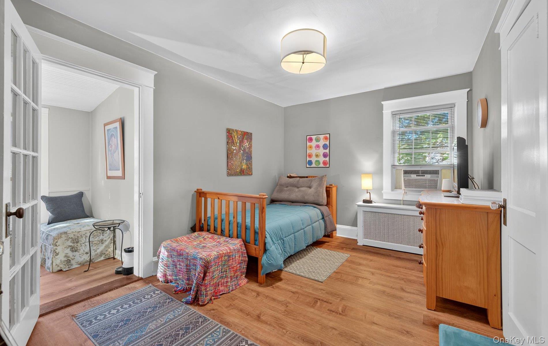 7 Ransom Avenue Sea Cliff, NY 11579 - Photo 27 of 42 a spacious bedroom with a bed and wooden floor