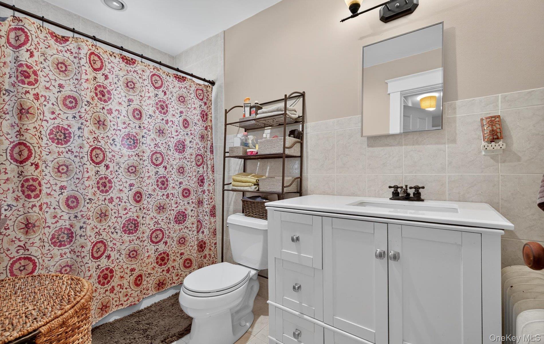 7 Ransom Avenue Sea Cliff, NY 11579 - Photo 30 of 42 a bathroom with a sink toilet and mirror