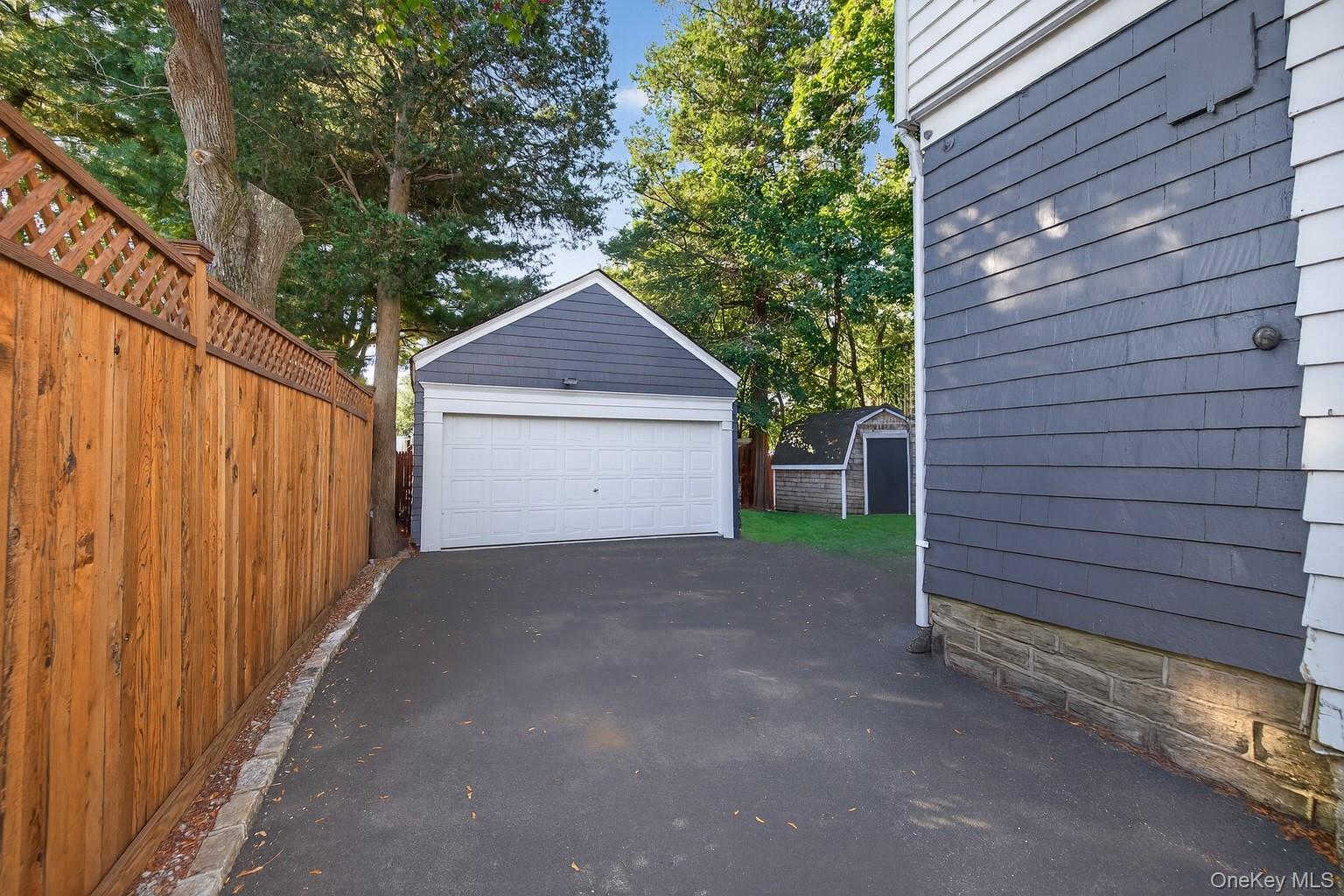 7 Ransom Avenue Sea Cliff, NY 11579 - Photo 37 of 42 a view of a house with a garage and yard